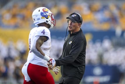 Sep 10, 2022; Morgantown, West Virginia, USA; Kansas Jayhawks head coach Lance Leipold talks to running back Devin Neal (4) during the second quarter against the West Virginia Mountaineers at Mountaineer Field at Milan Puskar Stadium. Mandatory Credit: Ben Queen-USA TODAY Sports