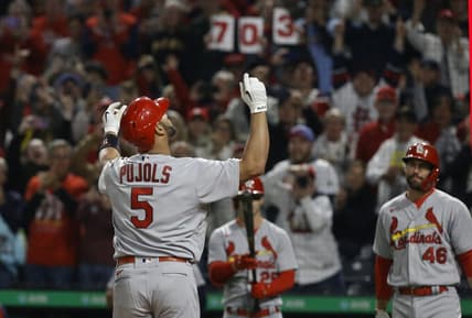 Oct 3, 2022; Pittsburgh, Pennsylvania, USA;  St. Louis Cardinals designated hitter Albert Pujols (5) reacts as he crosses home plate on a two run home run against the Pittsburgh Pirates during the sixth inning at PNC Park. The home run was the 703rd of Pujols career and the two runs batted in moved him into second place on the all-time MLB RBI list with 2216 runs batted in. Mandatory Credit: Charles LeClaire-USA TODAY Sports