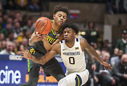 Jan 11, 2023; Morgantown, West Virginia, USA; West Virginia Mountaineers guard Kedrian Johnson (0) collides with Baylor Bears guard Keyonte George (1) while chasing the ball during the second half at WVU Coliseum. Mandatory Credit: Ben Queen-USA TODAY Sports