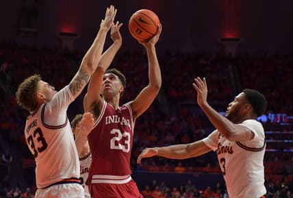 Jan 19, 2023; Champaign, Illinois, USA;  Indiana Hoosiers forward Trayce Jackson-Davis (23) drives to the basket between Illinois Fighting Illini forward Coleman Hawkins (33) and Jayden Epps (3) during the second half at State Farm Center. Mandatory Credit: Ron Johnson-USA TODAY Sports