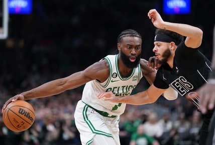 Feb 1, 2023; Boston, Massachusetts, USA; Boston Celtics guard Jaylen Brown (7) drives the ball against Brooklyn Nets guard Seth Curry (30) in the first quarter at TD Garden. Mandatory Credit: David Butler II-USA TODAY Sports
