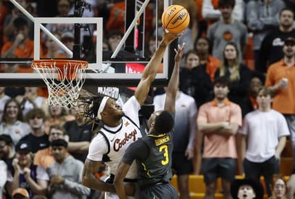 Feb 27, 2023; Stillwater, Oklahoma, USA; Oklahoma State Cowboys forward Tyreek Smith (23) blocks a shot by Baylor Bears guard Dale Bonner (3) during the first half at Gallagher-Iba Arena. Mandatory Credit: Alonzo Adams-USA TODAY Sports
