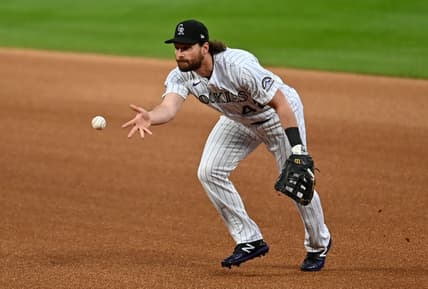Aug 28, 2020; Denver, Colorado, USA; Colorado Rockies first baseman Daniel Murphy (9) fields the ball in the first inning against the San Diego Padres at Coors Field. Mandatory Credit: Ron Chenoy-USA TODAY Sports