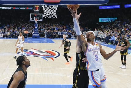 Mar 7, 2023; Oklahoma City, Oklahoma, USA; Oklahoma City Thunder guard Shai Gilgeous-Alexander (2) goes to the basket in front of Golden State Warriors guard Klay Thompson (11) during the first half at Paycom Center. Oklahoma City won 137-128. Mandatory Credit: Alonzo Adams-USA TODAY Sports
