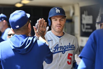 May 10, 2023; Milwaukee, Wisconsin, USA; Los Angeles Dodgers first baseman Freddie Freeman (5) is congratulated in the dug out after hitting a home run against the Milwaukee Brewers in the fourth inning at American Family Field. Mandatory Credit: Michael McLoone-USA TODAY Sports