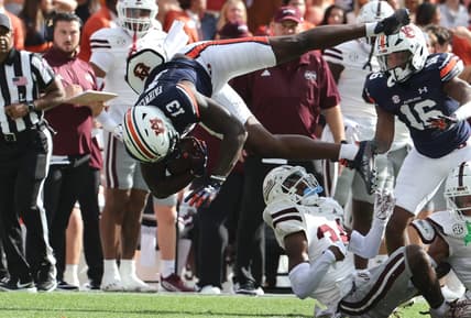 Oct 28, 2023; Auburn, Alabama, USA;  Auburn Tigers tight end Rivaldo Fairweather (13) is flipped up by Mississippi State Bulldogs cornerback Brice Pollock (34) during the first quarter at Jordan-Hare Stadium. Mandatory Credit: John Reed-USA TODAY Sports