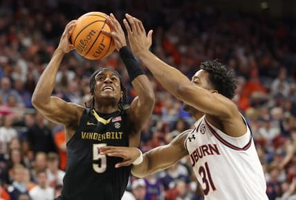 Jan 31, 2024; Auburn, Alabama, USA; Vanderbilt Commodores guard Ezra Manjon (5) takes a shot over Auburn Tigers guard Chaney Johnson (31) during the first half at Neville Arena. Mandatory Credit: John Reed-USA TODAY Sports