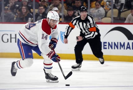 Feb 22, 2024; Pittsburgh, Pennsylvania, USA; Montreal Canadiens center Nick Suzuki (14) skates up ice with the puck against the Pittsburgh Penguins during the second period at PPG Paints Arena. Mandatory Credit: Charles LeClaire-USA TODAY Sports
