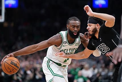 Feb 1, 2023; Boston, Massachusetts, USA; Boston Celtics guard Jaylen Brown (7) drives the ball against Brooklyn Nets guard Seth Curry (30) in the first quarter at TD Garden. Mandatory Credit: David Butler II-USA TODAY Sports