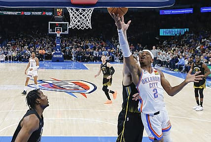 Mar 7, 2023; Oklahoma City, Oklahoma, USA; Oklahoma City Thunder guard Shai Gilgeous-Alexander (2) goes to the basket in front of Golden State Warriors guard Klay Thompson (11) during the first half at Paycom Center. Oklahoma City won 137-128. Mandatory Credit: Alonzo Adams-USA TODAY Sports
