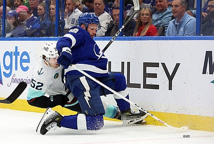 Oct 30, 2023; Tampa, Florida, USA; Seattle Kraken left wing Tye Kartye (52) and Tampa Bay Lightning defenseman Mikhail Sergachev (98) fight to control the puck during the second period at Amalie Arena. Mandatory Credit: Kim Klement Neitzel-USA TODAY Sports