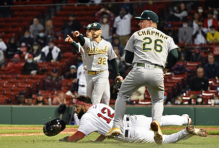 May 12, 2021; Boston, Massachusetts, USA;  Oakland Athletics third baseman Matt Chapman (26) tags out Boston Red Sox second baseman Marwin Gonzalez (12) who was caught in a run down during the fifth inning at Fenway Park. Mandatory Credit: Bob DeChiara-USA TODAY Sports