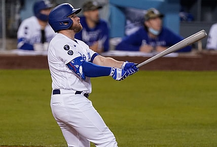 May 14, 2021; Los Angeles, California, USA; Los Angeles Dodgers first baseman Max Muncy (13) watches his three-run homer clear the fence in the second inning against the Miami Marlins at Dodger Stadium. Mandatory Credit: Robert Hanashiro-USA TODAY Sports
