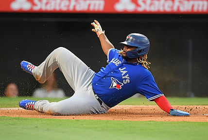 Aug 10, 2021; Anaheim, California, USA;  Toronto Blue Jays first baseman Vladimir Guerrero Jr. beats the throw to Los Angeles Angels catcher Kurt Suzuki (24) to score a run in the first inning of the game at Angel Stadium. Mandatory Credit: Jayne Kamin-Oncea-USA TODAY Sports