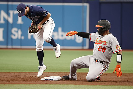 Aug 19, 2021; St. Petersburg, Florida, USA; Baltimore Orioles catcher Pedro Severino (28) doubles as Tampa Bay Rays second baseman Brandon Lowe (8) attempted to force him out at Tropicana Field. Mandatory Credit: Kim Klement-USA TODAY Sports
