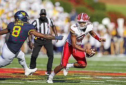 Sep 4, 2021; College Park, Maryland, USA; Maryland Terrapins quarterback Taulia Tagovailoa (3) escapes the pocket and pressure from West Virginia Mountaineers linebacker VanDarius Cowan (8) during the second quarter at Capital One Field at Maryland Stadium. Mandatory Credit: Ben Queen-USA TODAY Sports