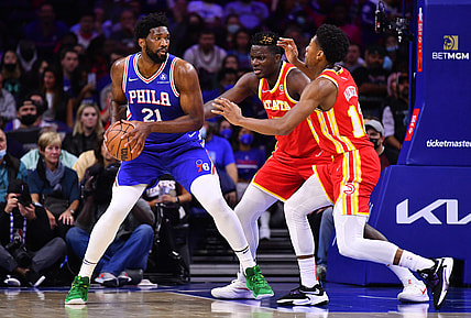 Oct 30, 2021; Philadelphia, Pennsylvania, USA; Philadelphia 76ers center Joel Embiid (21) controls the ball against Atlanta Hawks center Clint Capela (15) and forward De'Andre Hunter (12) in the first quarter at Wells Fargo Center. Mandatory Credit: Kyle Ross-USA TODAY Sports
