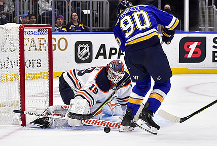 Nov 14, 2021; St. Louis, Missouri, USA;  Edmonton Oilers goaltender Mikko Koskinen (19) defends the net against St. Louis Blues center Ryan O'Reilly (90) during the second period at Enterprise Center. Mandatory Credit: Jeff Curry-USA TODAY Sports