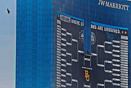 A bird gets an aerial view as the giant March Madness basketball bracket sign begins to come down Tuesday, April 6, 2021 off the J.W. Marriott in downtown Indianapolis, after March Madness and Final Four finished.

With March Madness And Final Four Finished Signage Comes Down
