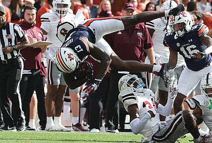 Oct 28, 2023; Auburn, Alabama, USA;  Auburn Tigers tight end Rivaldo Fairweather (13) is flipped up by Mississippi State Bulldogs cornerback Brice Pollock (34) during the first quarter at Jordan-Hare Stadium. Mandatory Credit: John Reed-USA TODAY Sports