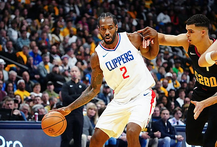 Nov 14, 2023; Denver, Colorado, USA; LA Clippers forward Kawhi Leonard (2) drives to the basket against Denver Nuggets forward Michael Porter Jr. (1) in the second quarter at Ball Arena. Mandatory Credit: Ron Chenoy-USA TODAY Sports