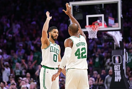 Mar 9, 2024; Phoenix, Arizona, USA; Boston Celtics forward Jayson Tatum (0) and Boston Celtics center Al Horford (42) slap hands during the second half of the game against the Phoenix Suns at Footprint Center. Mandatory Credit: Joe Camporeale-USA TODAY Sports