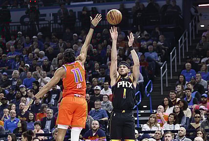 Mar 29, 2024; Oklahoma City, Oklahoma, USA; Phoenix Suns guard Devin Booker (1) shoots a three-point basket as Oklahoma City Thunder guard Isaiah Joe (11) defends during the first half at Paycom Center. Mandatory Credit: Alonzo Adams-USA TODAY Sports