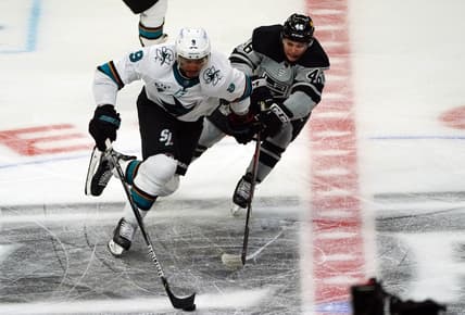Apr 3, 2021; Los Angeles, California, USA; San Jose Sharks left wing Evander Kane (9) moves the puck against Los Angeles Kings center Blake Lizotte (46) during the third period at Staples Center. Mandatory Credit: Gary A. Vasquez-USA TODAY Sports