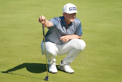 Jul 16, 2021; Sandwich, England, GB; Mackenzie Hughes  lines up a putt on the sixth green during the second  round of the Open Championship golf tournament. Mandatory Credit: Peter van den Berg-USA TODAY Sports