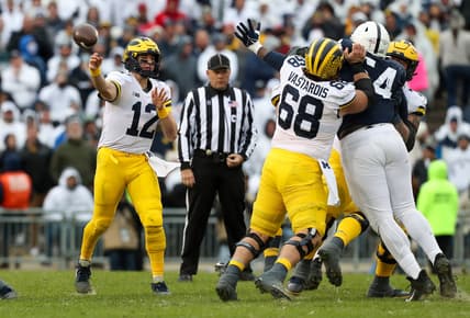 Nov 13, 2021; University Park, Pennsylvania, USA; Michigan Wolverines quarterback Cade McNamara (12) throws a pass during the third quarter against the Penn State Nittany Lions at Beaver Stadium. Michigan defeated Penn State 21-17. Mandatory Credit: Matthew OHaren-USA TODAY Sports