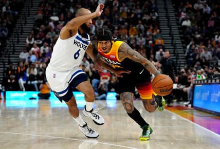 Dec 31, 2021; Salt Lake City, Utah, USA; Utah Jazz guard Jordan Clarkson (00) drives past Minnesota Timberwolves guard Jordan McLaughlin (6) in the second half at Vivint Arena. Mandatory Credit: Ron Chenoy-USA TODAY Sports