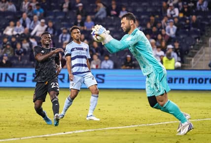 May 25, 2022; Kansas City, Kansas, USA; Houston Dynamo forward Carlos Darwin Quintero (23) reacts after a stop by Sporting Kansas City goalkeeper John Pulskamp (1) as defender Kayden Pierre (24) looks on during the second half at Children's Mercy Park. Mandatory Credit: Jay Biggerstaff-USA TODAY Sports