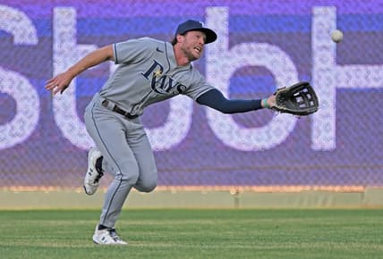 Jul 22, 2022; Kansas City, Missouri, USA;  Tampa Bay Rays center fielder Brett Phillips (35) reaches to make a running catch during the first inning against the Kansas City Royals at Kauffman Stadium. Mandatory Credit: Peter Aiken-USA TODAY Sports