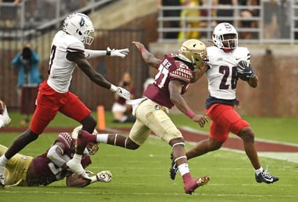 Aug 27, 2022; Tallahassee, Florida, USA; Duquesne Dukes running back Demarcus Ware (28) runs the ball past Florida State Seminoles defensive back Akeem Dent Sr. (27) during the first half at Doak S. Campbell Stadium. Mandatory Credit: Melina Myers-USA TODAY Sports