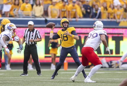 Sep 10, 2022; Morgantown, West Virginia, USA; West Virginia Mountaineers quarterback JT Daniels (18) throws a pass during the first quarter against the Kansas Jayhawks at Mountaineer Field at Milan Puskar Stadium. Mandatory Credit: Ben Queen-USA TODAY Sports