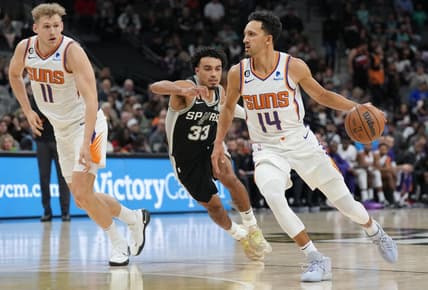 Dec 4, 2022; San Antonio, Texas, USA;  Phoenix Suns guard Landry Shamet (14) dribbles past San Antonio Spurs guard Tre Jones (33) in the first half at the AT&T Center. Mandatory Credit: Daniel Dunn-USA TODAY Sports