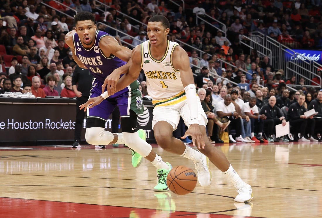 Dec 11, 2022; Houston, Texas, USA; Houston Rockets forward Jabari Smith Jr. (1) dribbles against Milwaukee Bucks forward Giannis Antetokounmpo (34) in the second half at Toyota Center. Mandatory Credit: Thomas B. Shea-USA TODAY Sports