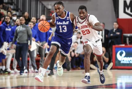 Feb 1, 2023; Queens, New York, USA;  Seton Hall Pirates forward KC Ndefo (13) looks to drive past St. John's Red Storm forward David Jones (23) in the first half at Carnesecca Arena. Mandatory Credit: Wendell Cruz-USA TODAY Sports