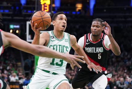 Mar 8, 2023; Boston, Massachusetts, USA; Boston Celtics guard Malcolm Brogdon (13) drives the ball against Portland Trail Blazers forward Cam Reddish (5) in the second half at TD Garden. Mandatory Credit: David Butler II-USA TODAY Sports