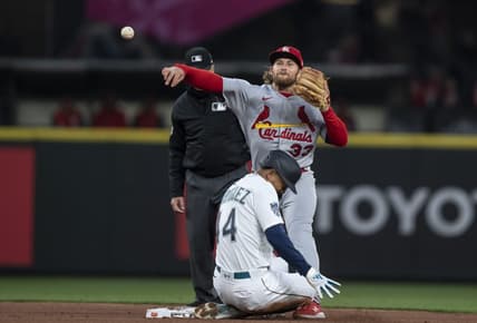 Apr 21, 2023; Seattle, Washington, USA; St. Louis Cardinals second baseman Brendan Donovan (33) turns a double play after forcing out Seattle Mariners centerfielder Julio Rodriguez (44) at second base during the third inning at T-Mobile Park. Mandatory Credit: Stephen Brashear-USA TODAY Sports