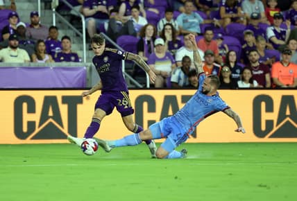 May 17, 2023; Orlando, Florida, USA; Orlando City SC defender Michael Halliday (26) dribbles the ball as New York City FC defender Maxime Chanot (4) defends during the first half at Exploria Stadium. Mandatory Credit: Kim Klement-USA TODAY Sports