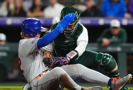 May 27, 2023; Denver, Colorado, USA; Colorado Rockies catcher Elias Diaz (35) tags out New York Mets third baseman Brett Baty (22) in the sixth inning at Coors Field. Mandatory Credit: Ron Chenoy-USA TODAY Sports