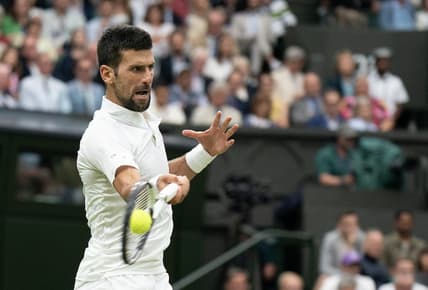 Jul 14, 2023; London, United Kingdom; Novak Djokovic (SRB) returns a shot during his match against Jannik Sinner (ITA) on day 12 at the All England Lawn Tennis and Croquet Club.  Mandatory Credit: Susan Mullane-USA TODAY Sports