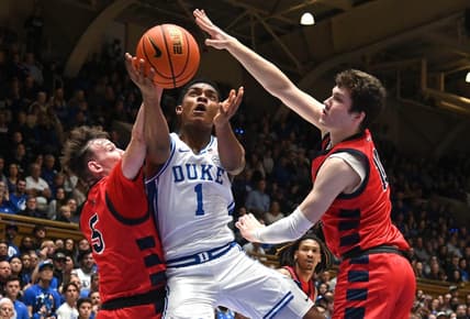 Nov 24, 2023; Durham, North Carolina, USA; Duke Blue Devils guard Caleb Foster (1) lays the ball up between Southern Indiana Screaming Eagles forward Jack Mielke (10) and guard Jack Campion (5) during the second half at Cameron Indoor Stadium. Mandatory Credit: Rob Kinnan-USA TODAY Sports