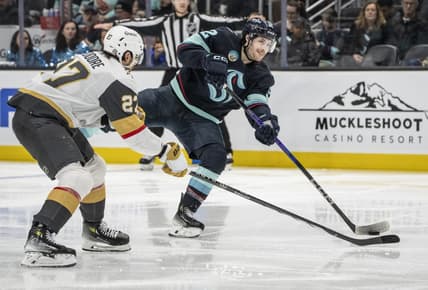 Mar 12, 2024; Seattle, Washington, USA; Seattle Kraken forward Tye Kartye (52) takes a shot Vegas Golden Knights defenseman Shea Theodore (27) during the second period at Climate Pledge Arena. Mandatory Credit: Stephen Brashear-USA TODAY Sports