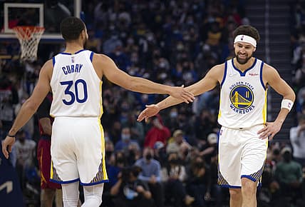 Jan 9, 2022; San Francisco, California, USA; Golden State Warriors guard Klay Thompson (11) gets a congratulatory handshake from teammate Stephen Curry (30) after making a basket against the Cleveland Cavaliers during the first quarter at Chase Center. Mandatory Credit: D. Ross Cameron-USA TODAY Sports
