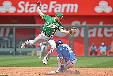 Jun 26, 2022; Kansas City, Missouri, USA;  Kansas City Royals second baseman Whit Merrifield (15) slides into second base, for a stolen base, under Oakland Athletics shortstop Nick Allen (2) during the third inning at Kauffman Stadium. Mandatory Credit: Peter Aiken-USA TODAY Sports