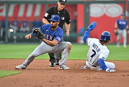 Jun 27, 2022; Kansas City, Missouri, USA;  Kansas City Royals shortstop Bobby Witt Jr. (7) steals second against Texas Rangers second baseman Marcus Semien (2) during the first inning at Kauffman Stadium. Mandatory Credit: Peter Aiken-USA TODAY Sports