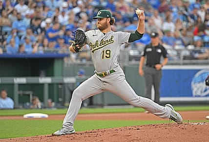 Jun 24, 2022; Kansas City, Missouri, USA; Oakland Athletics starting pitcher Cole Irvin (19) delivers a pitch during the first inning against the Kansas City Royals at Kauffman Stadium. Mandatory Credit: Peter Aiken-USA TODAY Sports