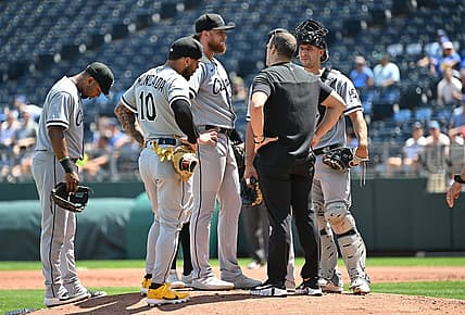 Aug 22, 2022; Kansas City, Missouri, USA;  Chicago White Sox starting pitcher Michael Kopech (34) talks with a trainer during the first inning against the Kansas City Royals at Kauffman Stadium. Mandatory Credit: Peter Aiken-USA TODAY Sports